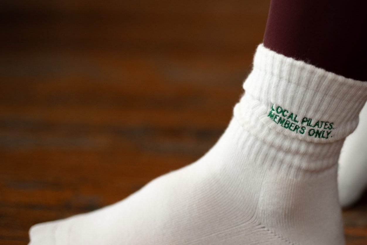 White custom grip sock on a blurred background