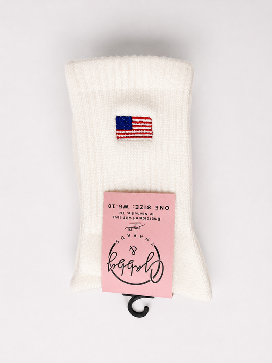 White sock with American flag design and pink label on a white background