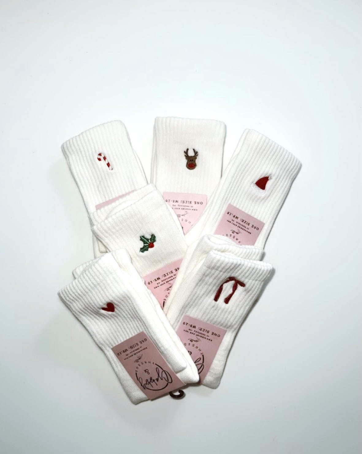 six pairs of embroidered grip socks featuring different christmas icons