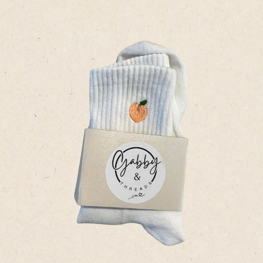 White grip socks with peach design embroidered 