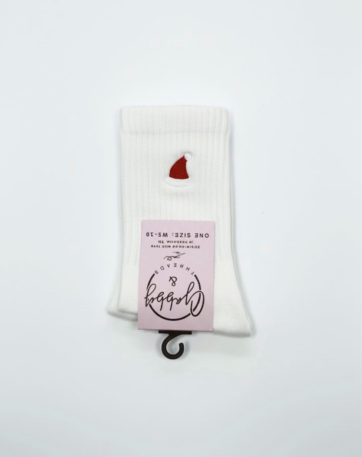 a pair of white grip socks with an embroidered santa hat on them