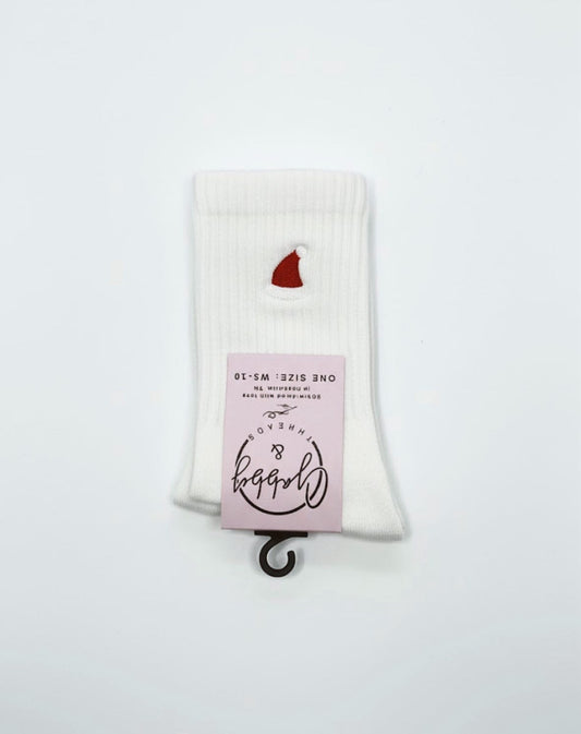 a pair of white grip socks with an embroidered santa hat on them
