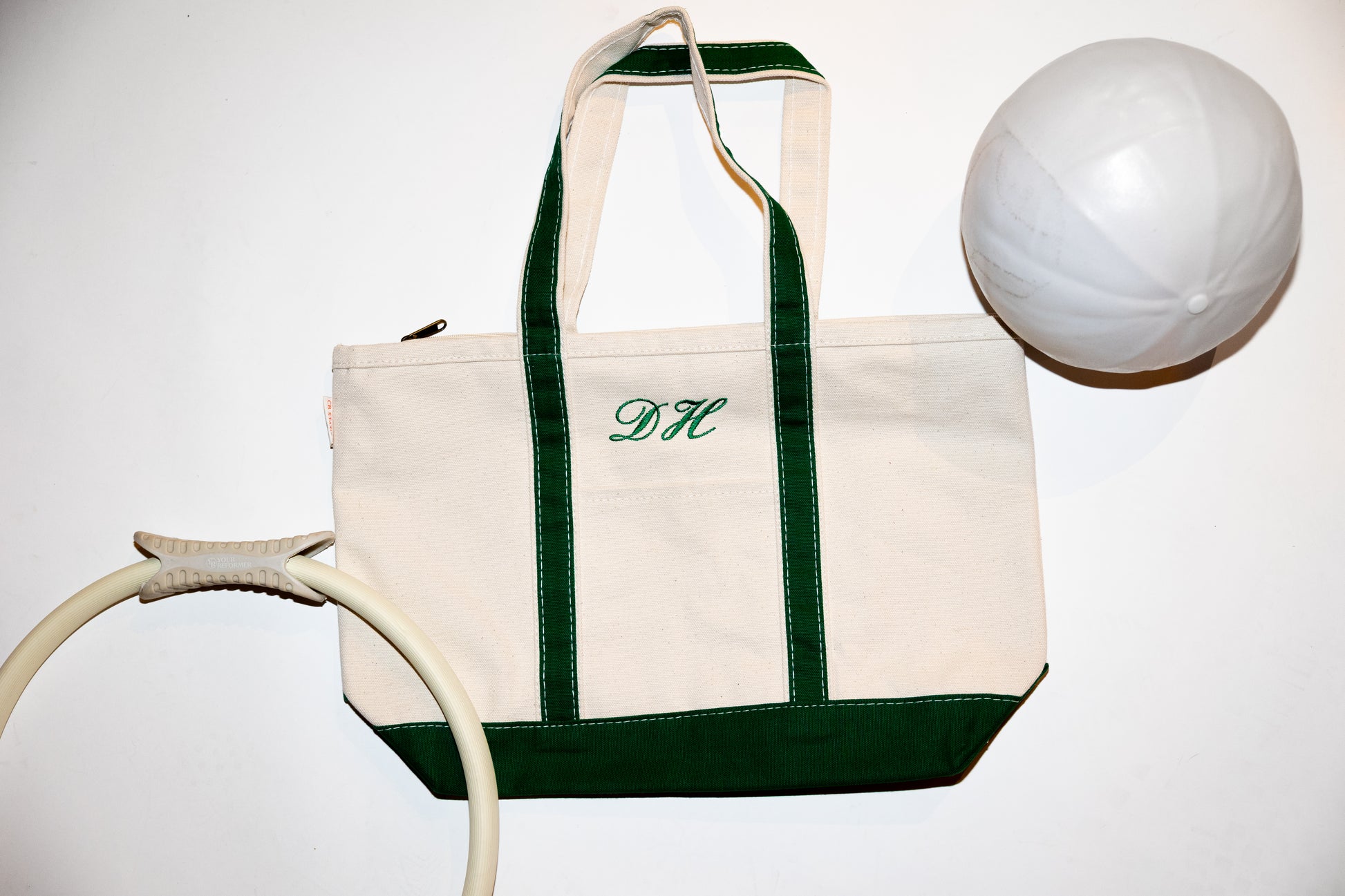 canvas  tote bag with green accents and  script text against a white background background