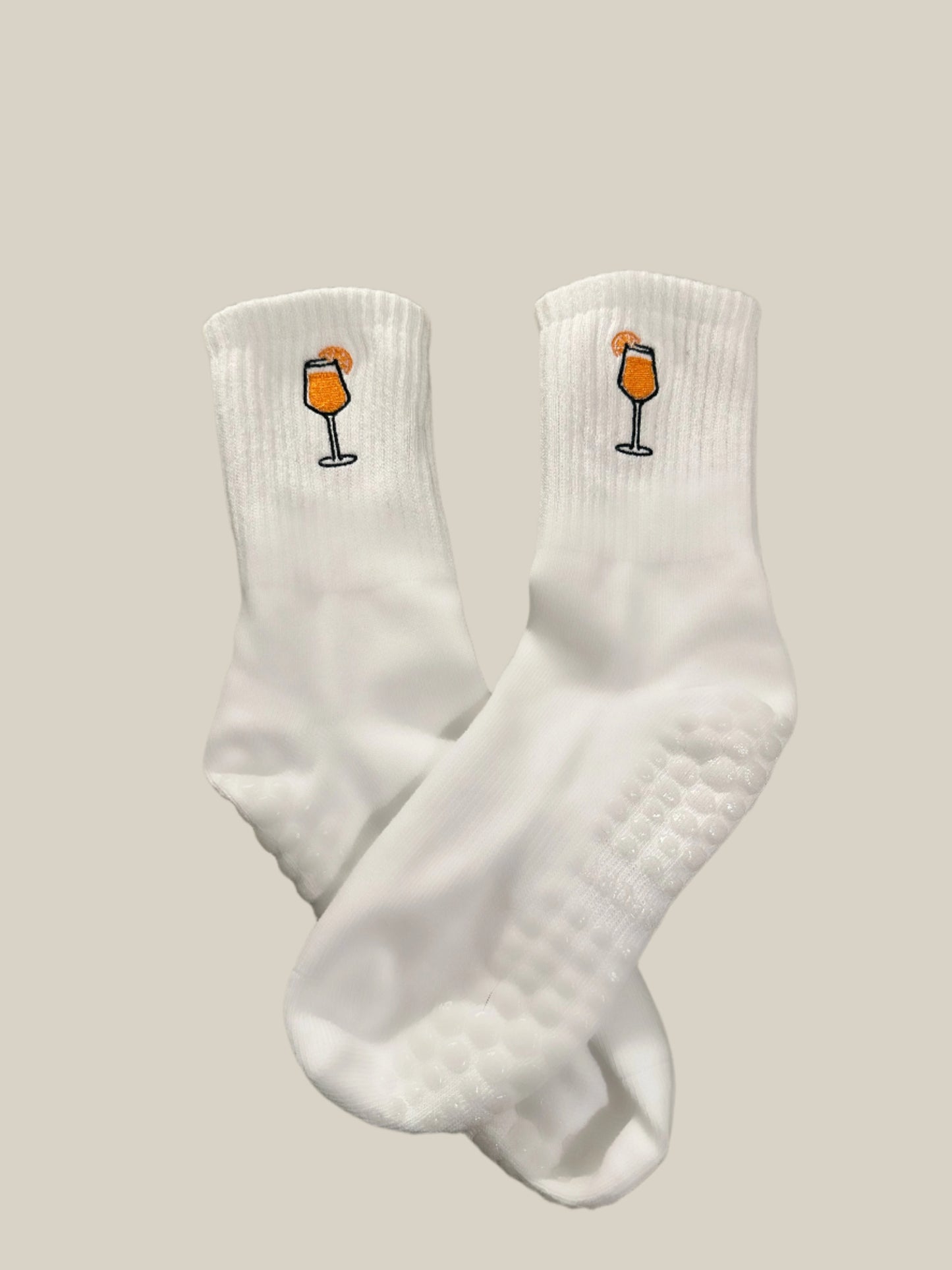 white grip socks with aperol spritz embroidered design