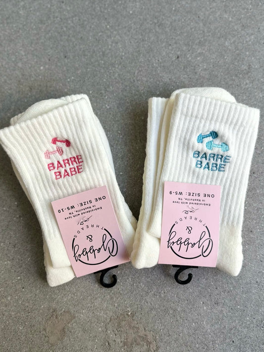 White grip socks with "BARRE BABE" embroidery and dumbbells