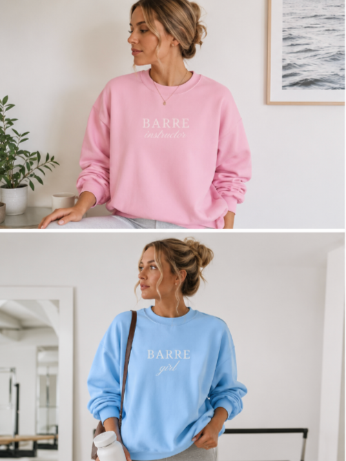Two women wearing pink and blue 'BARRE girl' sweatshirts in a home setting.