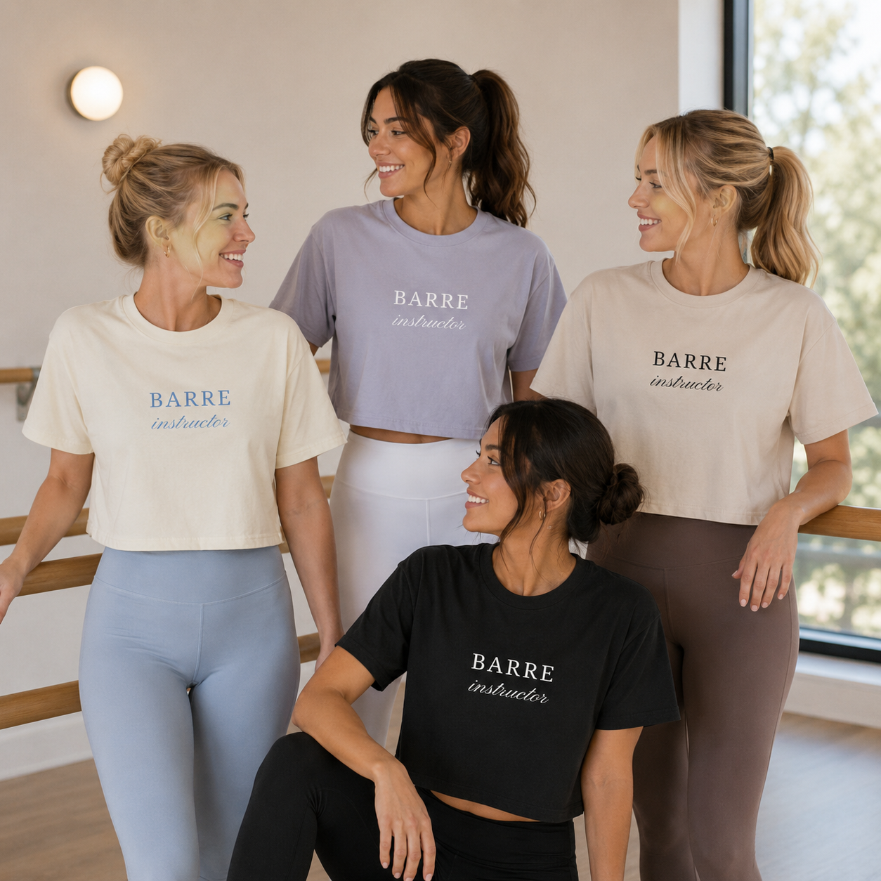 four women are in a barre studio wearing different cropped tshirts that have the words “barre instructor" embroidered on them