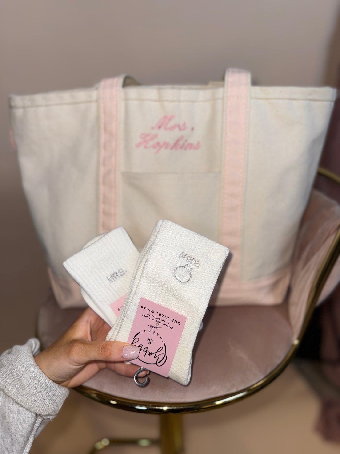 two pairs of bridal themed grip socks in front of a tote bag