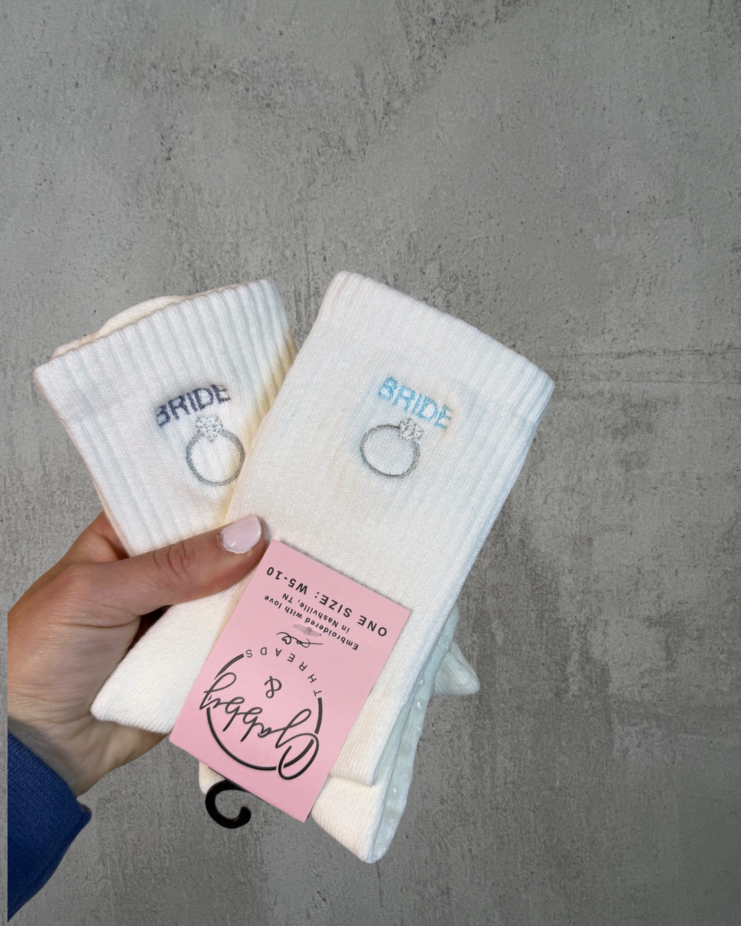 White grip socks with 'bride' and ring design against a gray background