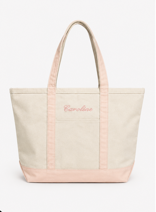 canvas tote bag with pink accents and 'Caroline' embroidery on a white background