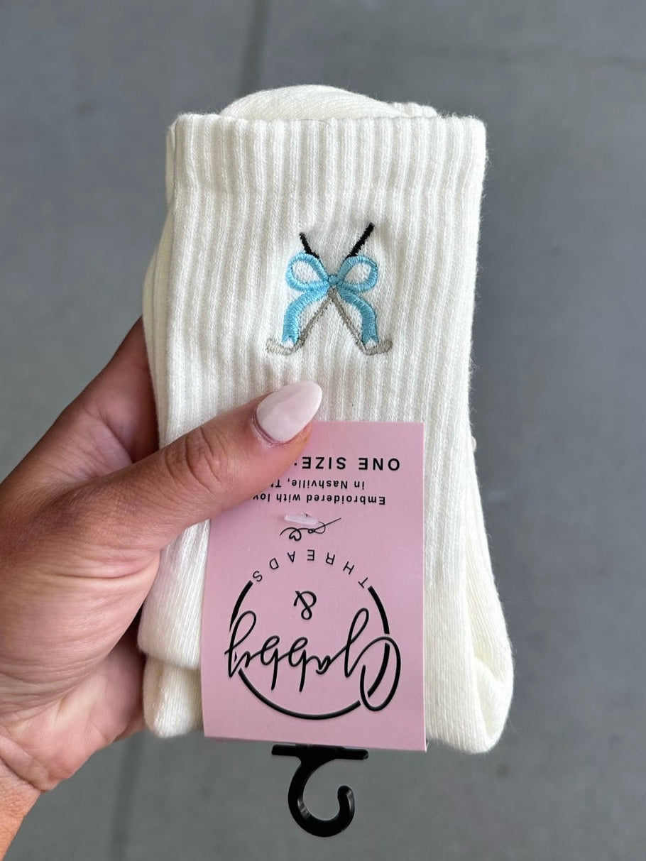 White socks with embroidered golf clubs with a blue coquette bow
