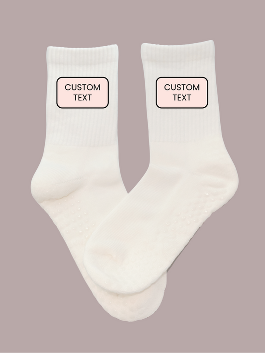 White grip socks with 'Custom Text' labels on a beige background