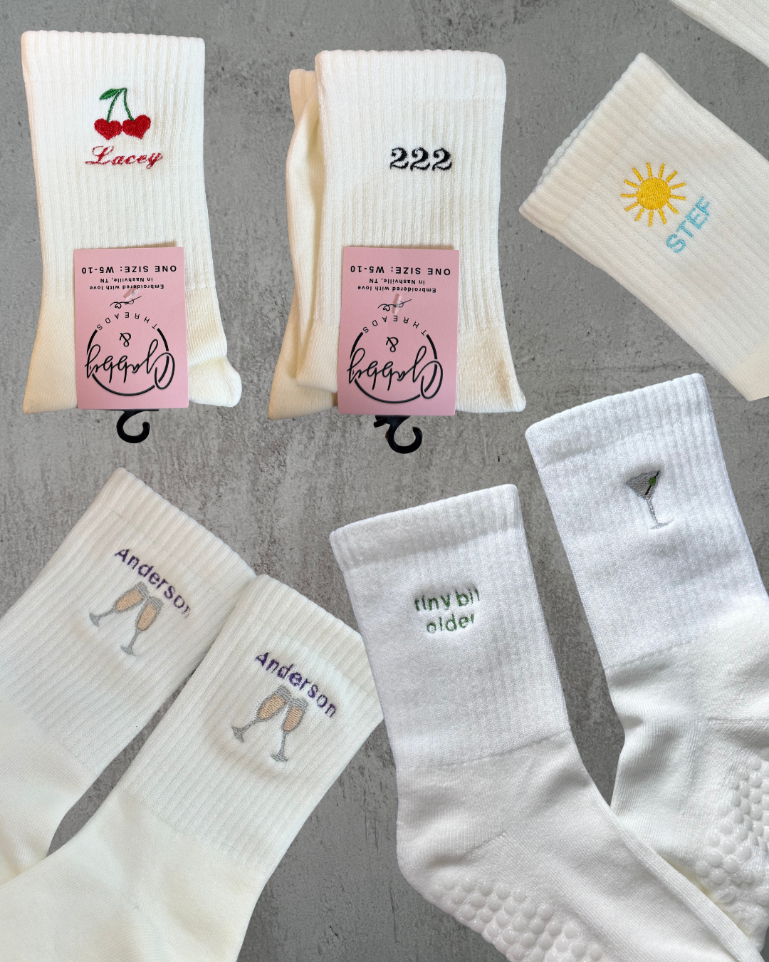 Collection of white socks with various designs and text on a gray background