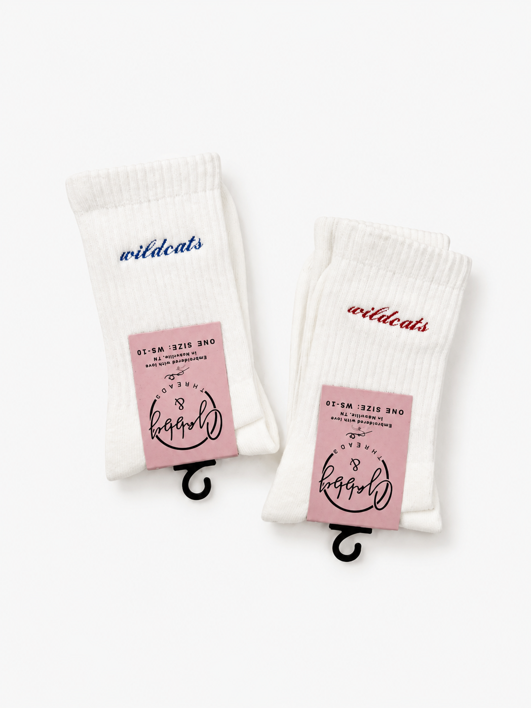 two pairs of white socks sitting against a white background with the word "wildcats" embroidered on them in script