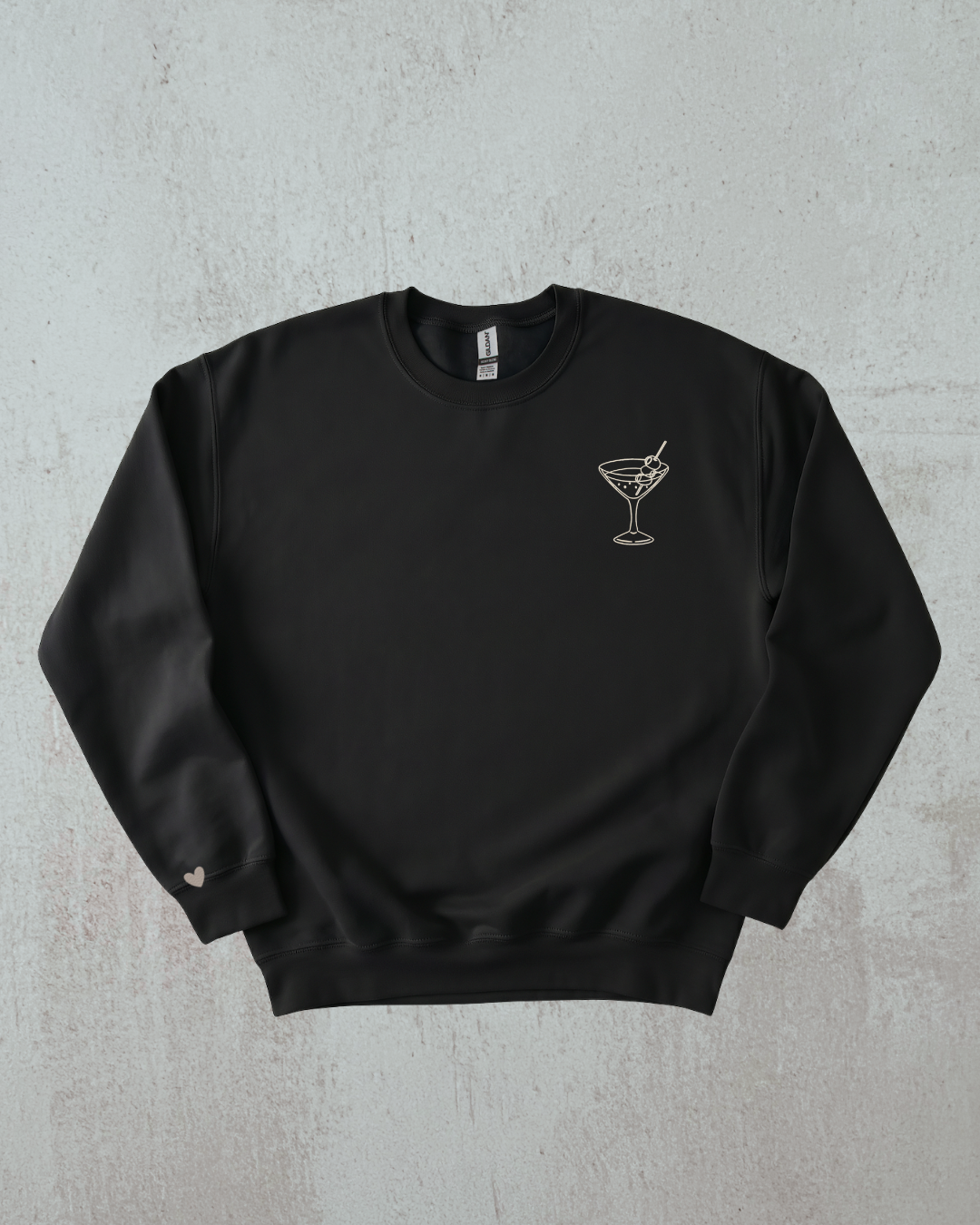 Black sweatshirt with a martini glass design on a gray background