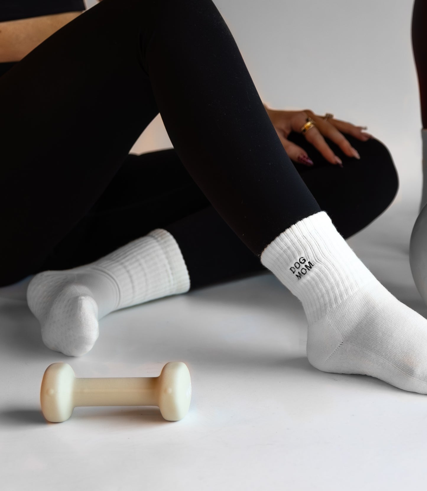 a person is wearing black leggings with white crew socks with the words dog mom embroidered on them