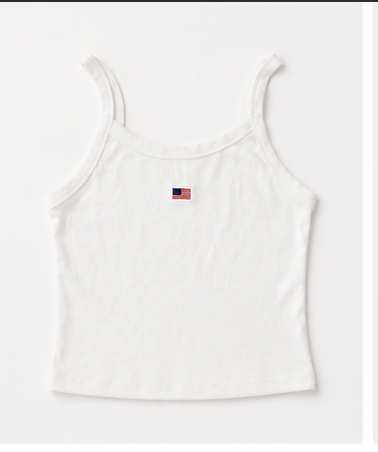 White tank top with a small flag patch on a light gray background