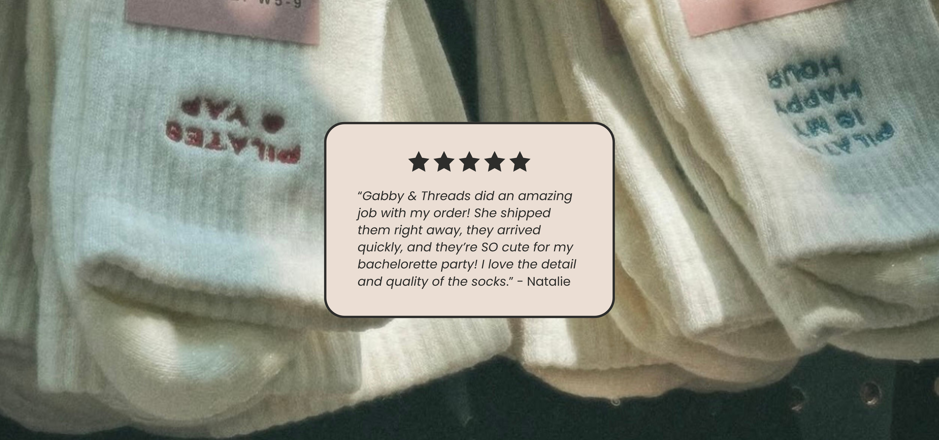 White socks with text on a black background, featuring a five-star rating and review.