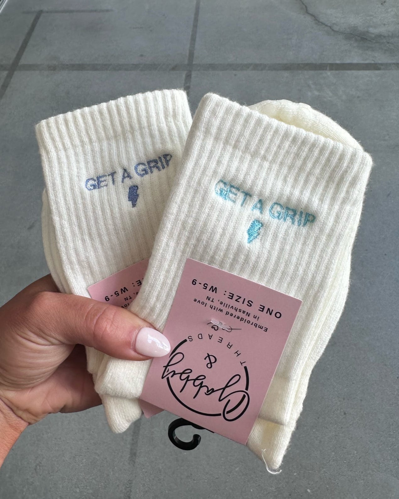 Grip socks that say "Get a Grip" with a lightening bolt