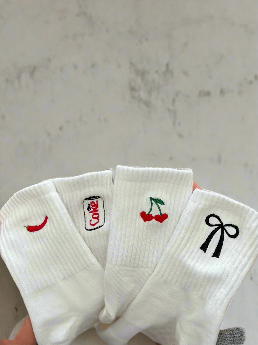 4 pairs of embroidered socks with different designs, a hot chili pepper, a diet coke, a cherry heart, and black coquette bow