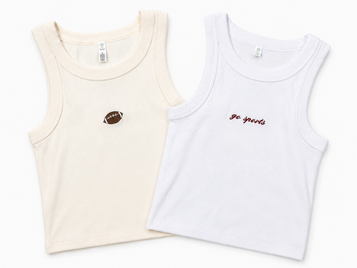 Two sleeveless tank tops laid flat on a white background: one cream with a small brown football patch on the chest, and one white with small red cursive text reading 'Go Sports' on the chest.