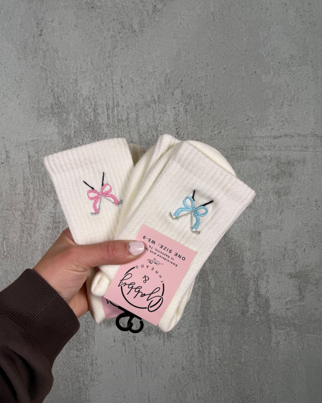 White socks with embroidered golf clubs with a blue coquette bow