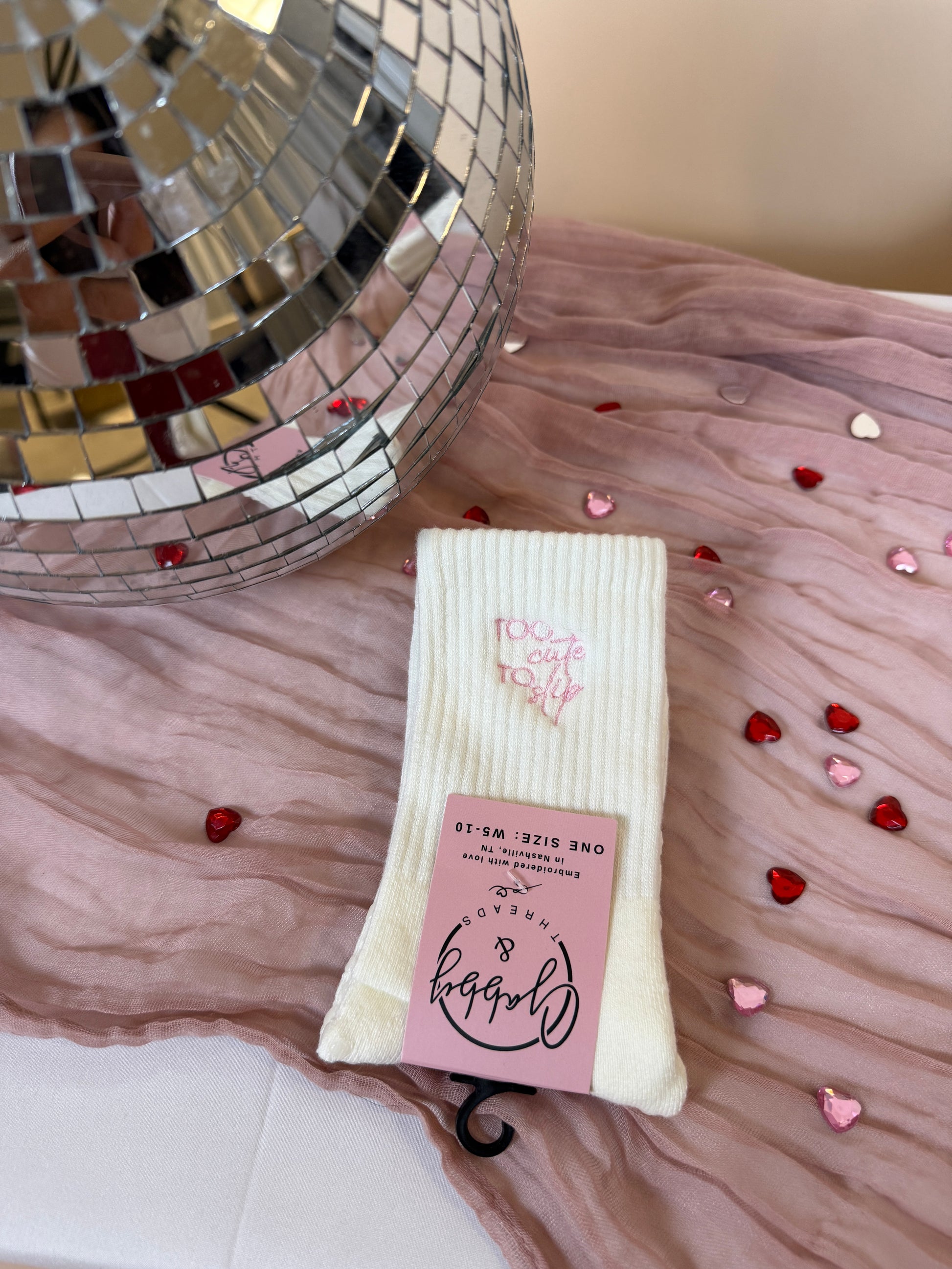 Grip Socks with the words "Too Cute to Slip" embroidered on them 