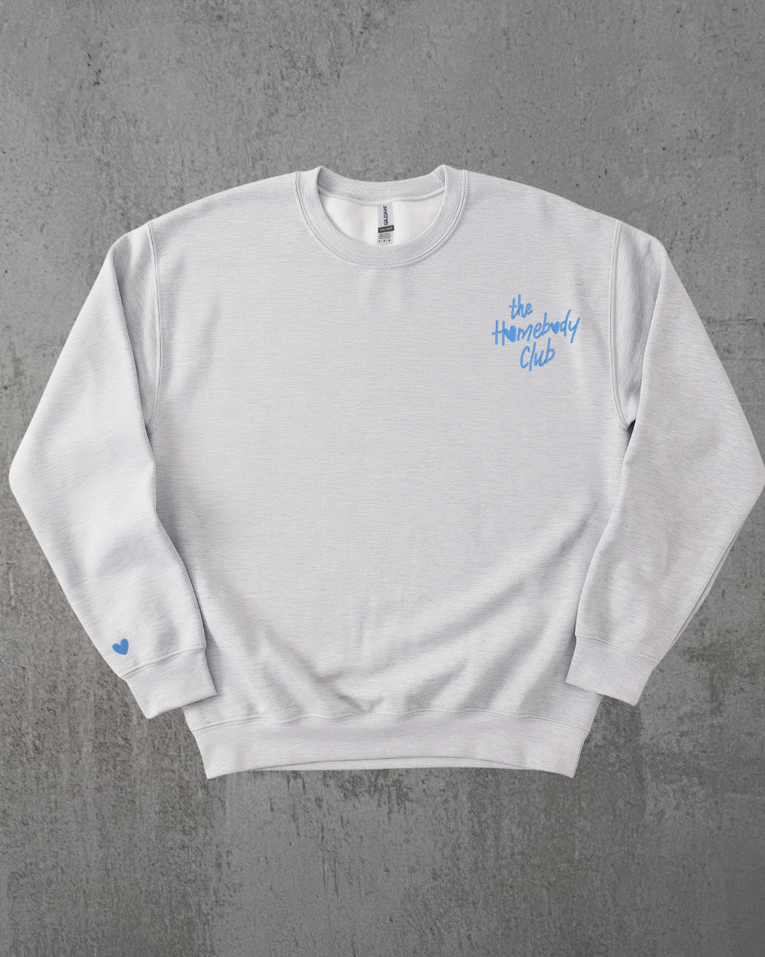 a gray sweatshirt with the words "the homebody club" embroidered on it