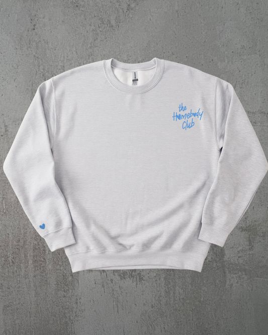 a gray sweatshirt with the words "the homebody club" embroidered on it