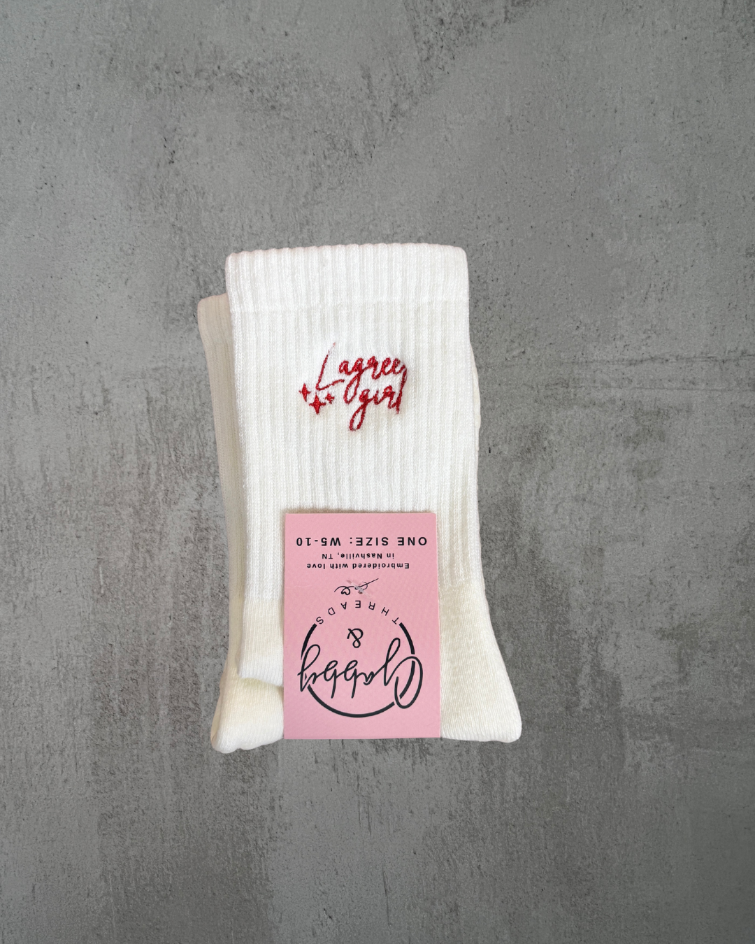 white grip socks with the words "lagree girl" embroidered on them