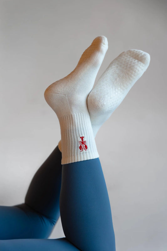 White socks with a lobster worn by a person against a plain background