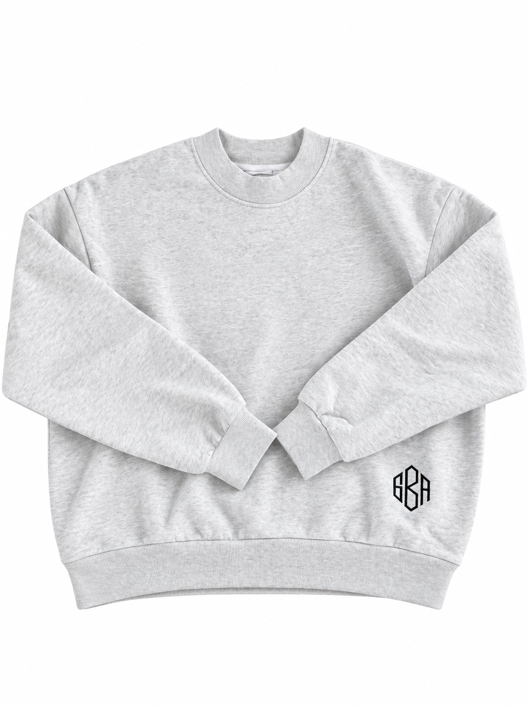 a heather gray mockneck with an embroidered monogram is laying against a white background