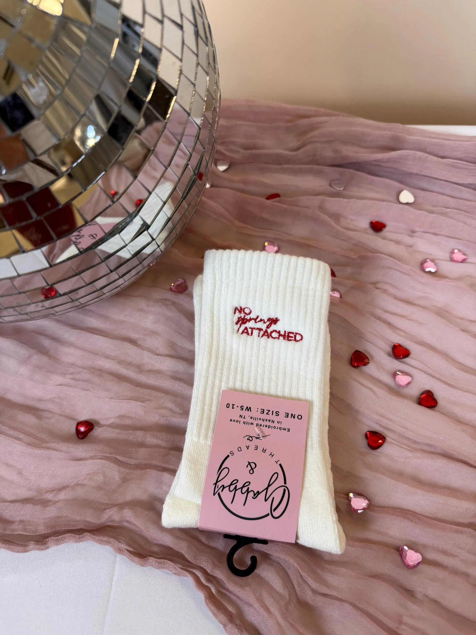 a pair of white grip socks with the words "no springs attached" embroidered on them