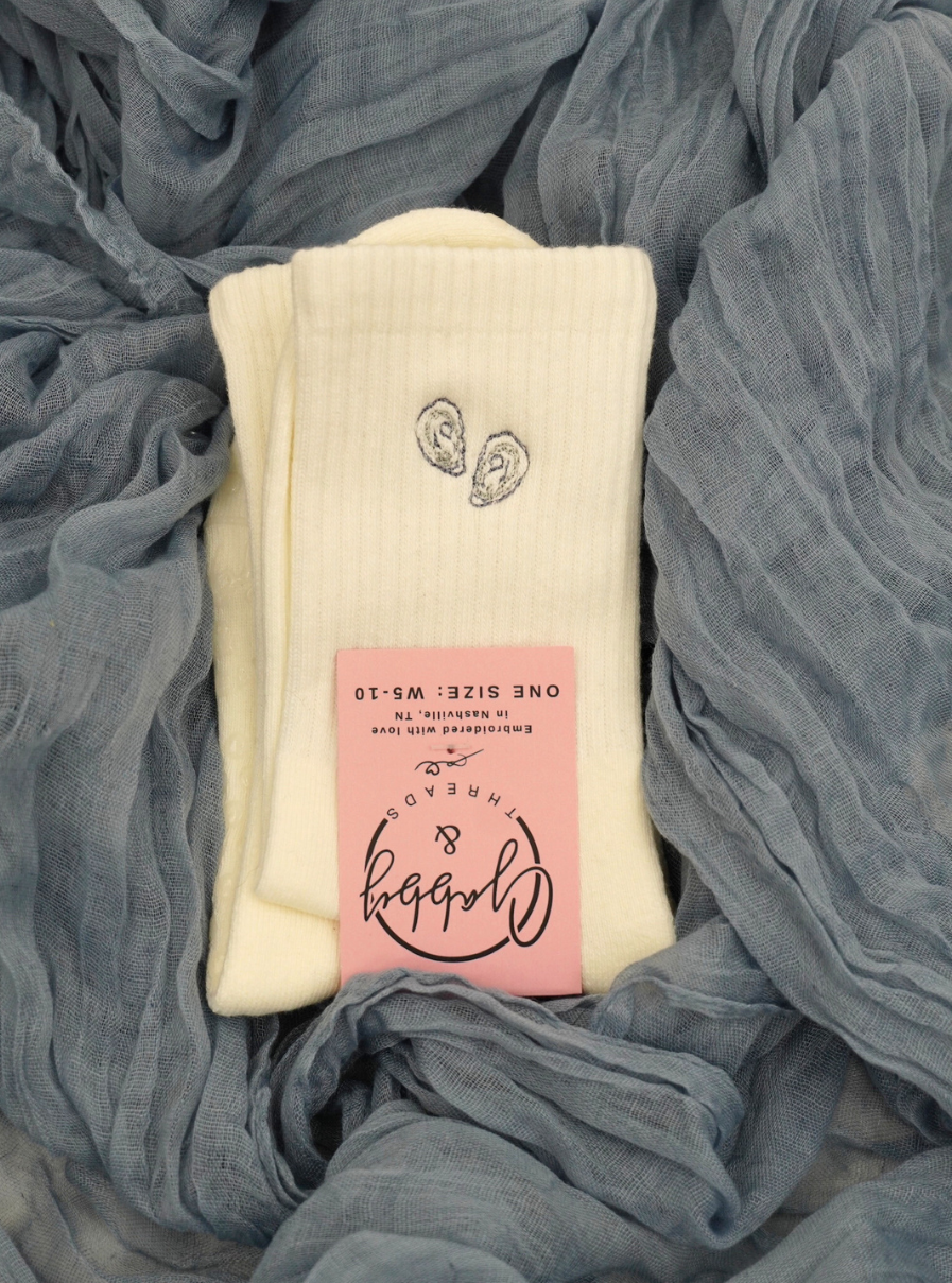 white grip socks with an embroidered oyster 