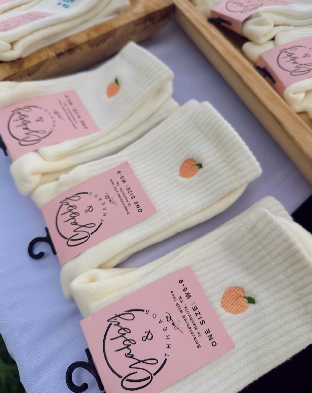 White socks with peaches embroidered on them 