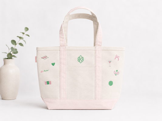 Light pink tote bag with embroidered designs on a white background