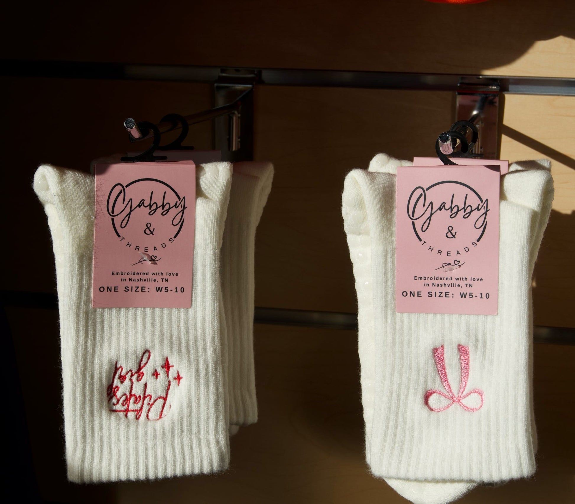 two pairs of grip socks hanging in a retail store 