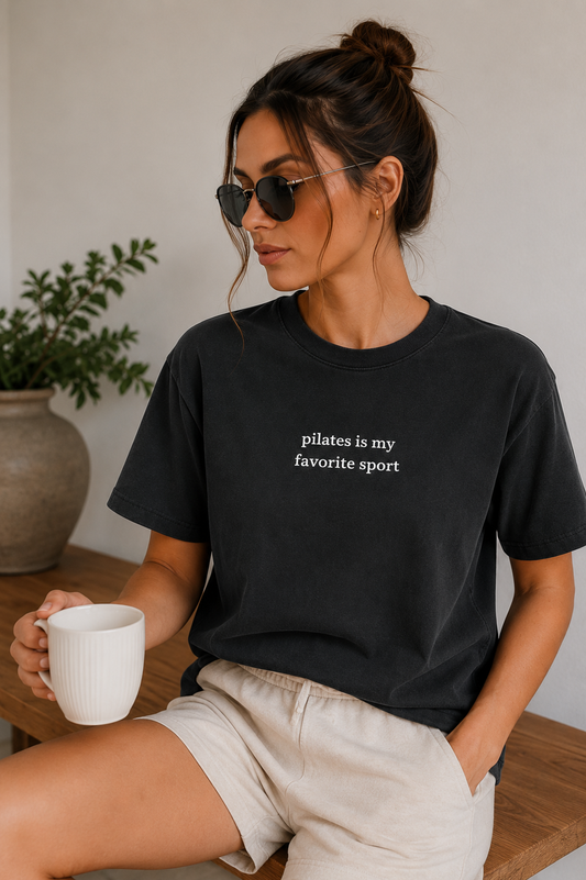 a women is wearing a tshirt that says "pilates is my favorite sport"