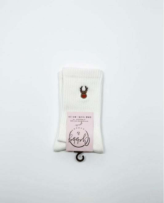 a pair of white grip socks with an embroidered reindeer on them