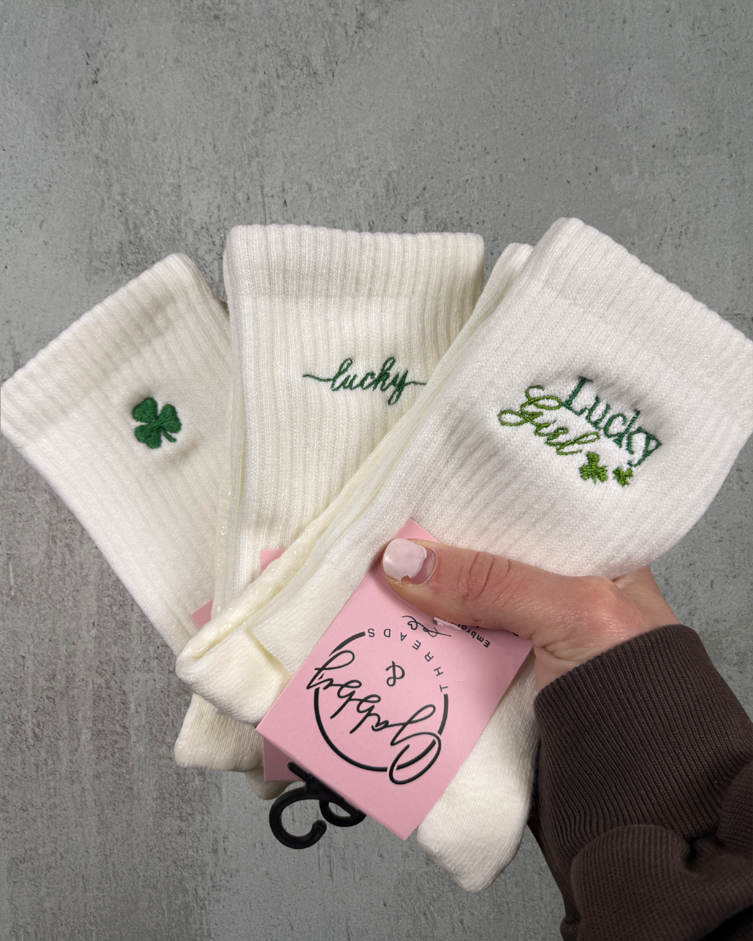 Three pairs of embroidered socks for pilates that are St. Patrick's Day themed