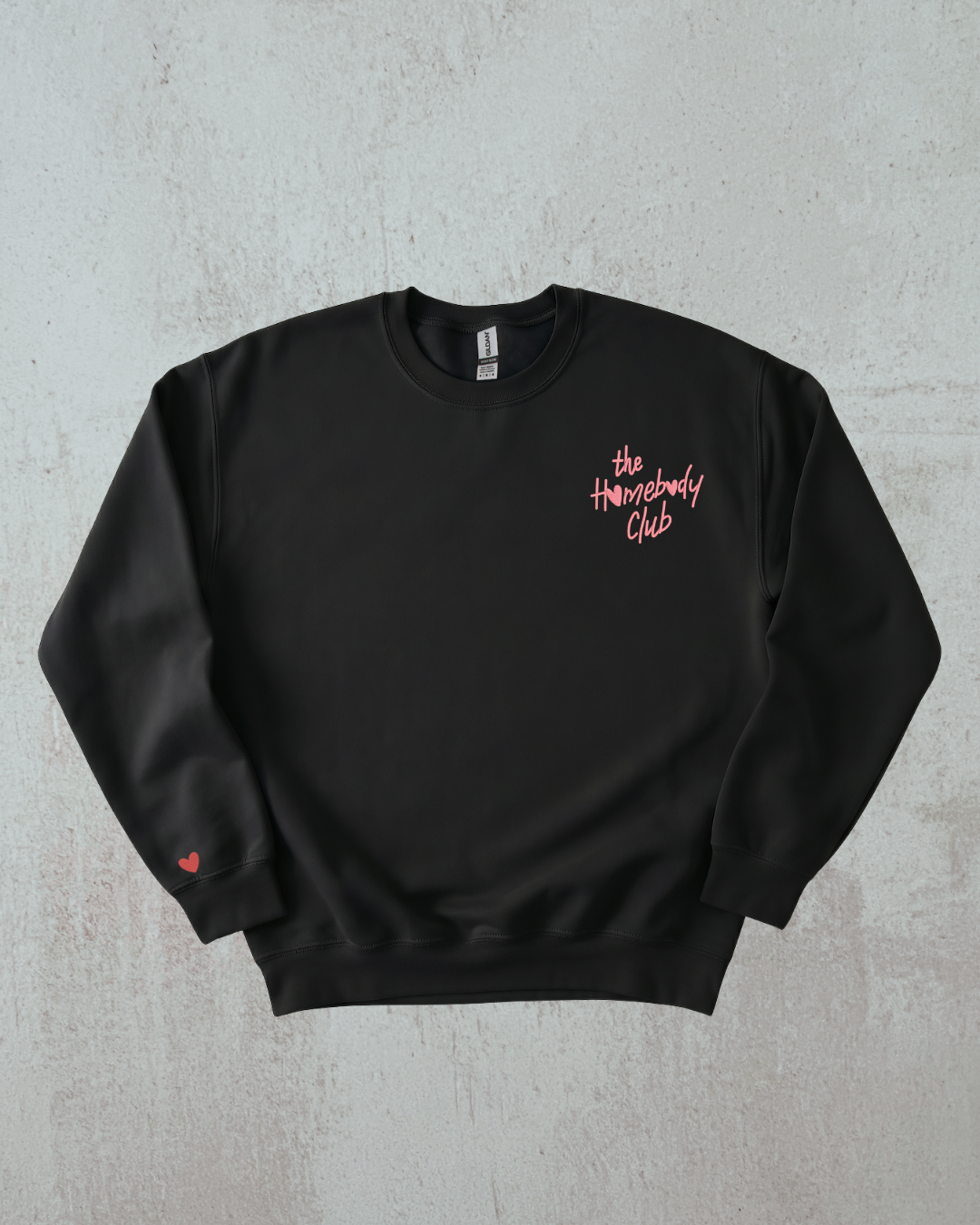 a black sweatshirt with the words "the homebody club" embroidered on it