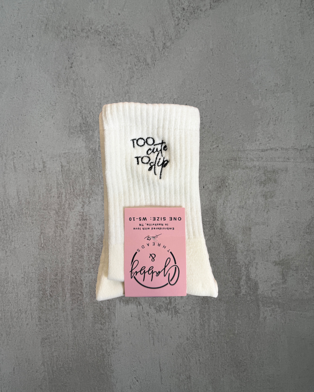 Grip Socks with the words "Too Cute to Slip" embroidered on them 