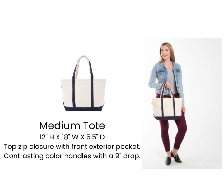 Medium tote bag with contrasting color handles, held by a person on a white background.