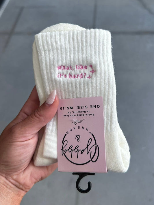 White grip socks with "What, like it's hard?" embroidered with sparkles