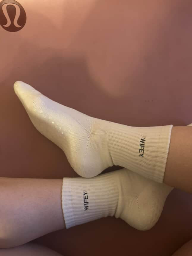 Grip socks with the word 'wifey' embroidered on them