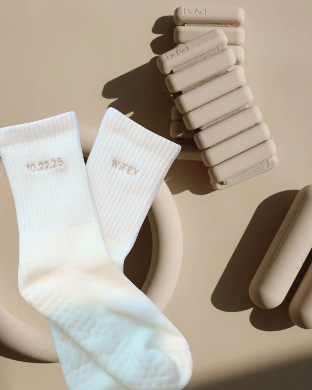 a pair of white grip socks with the words "wifey" and a wedding date embroidered on them next to bala bands