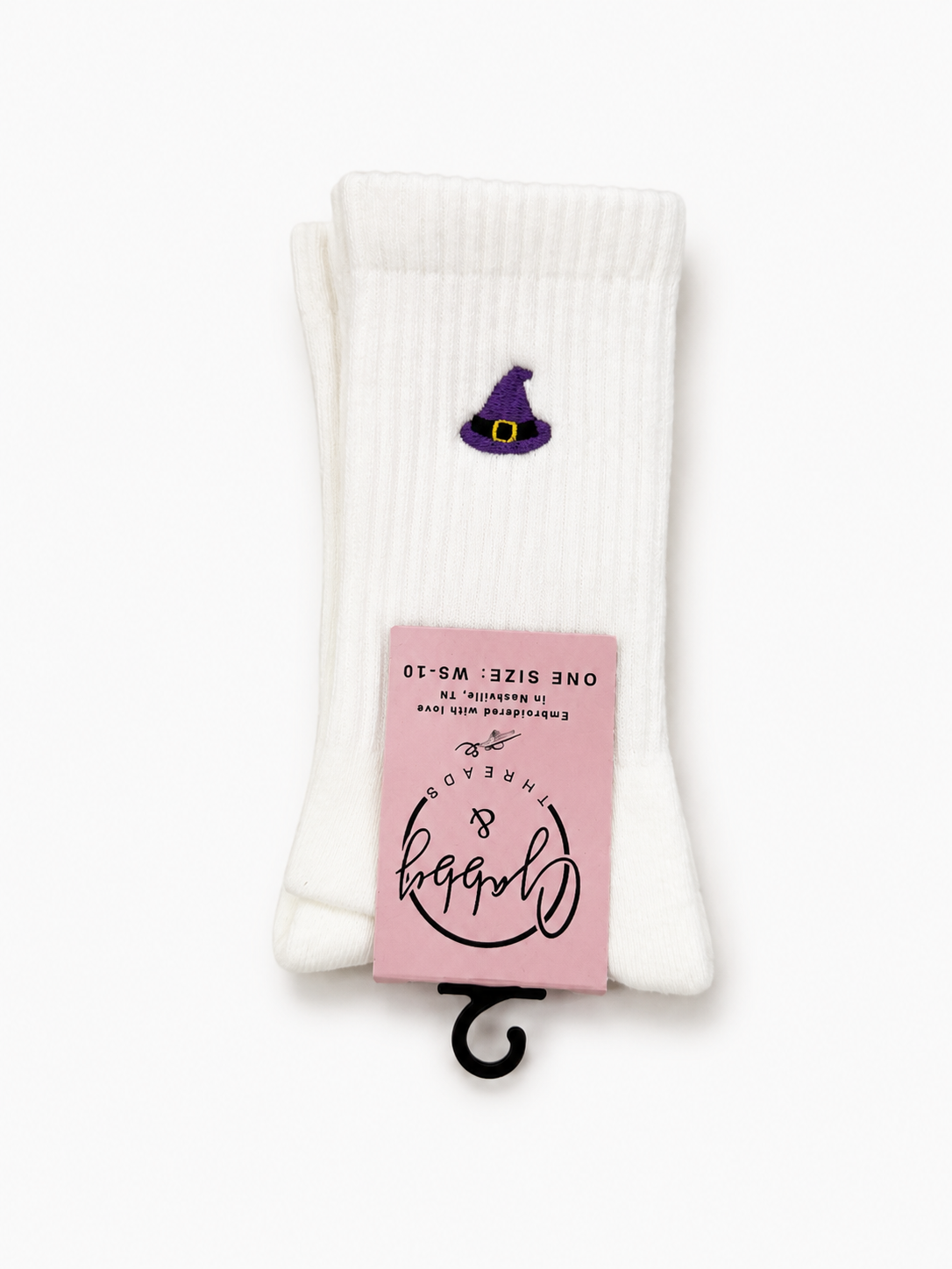 a pair of white socks with an embroidered witch hat on them