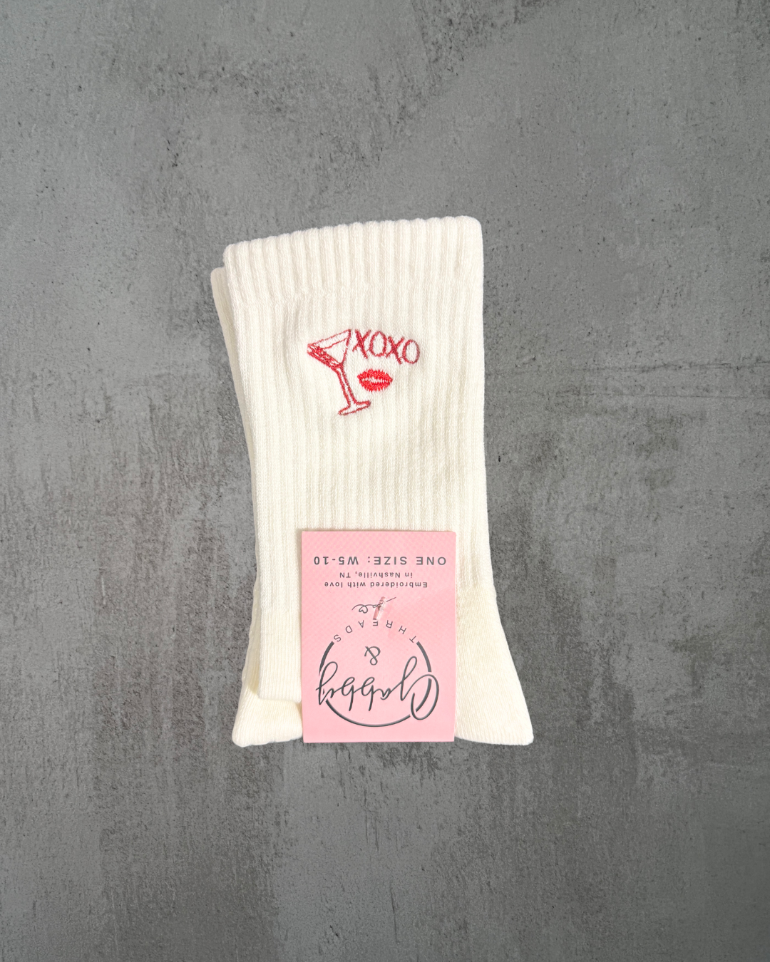 a pair of white grip socks with "xoxo," a Martini Glass and red lips
