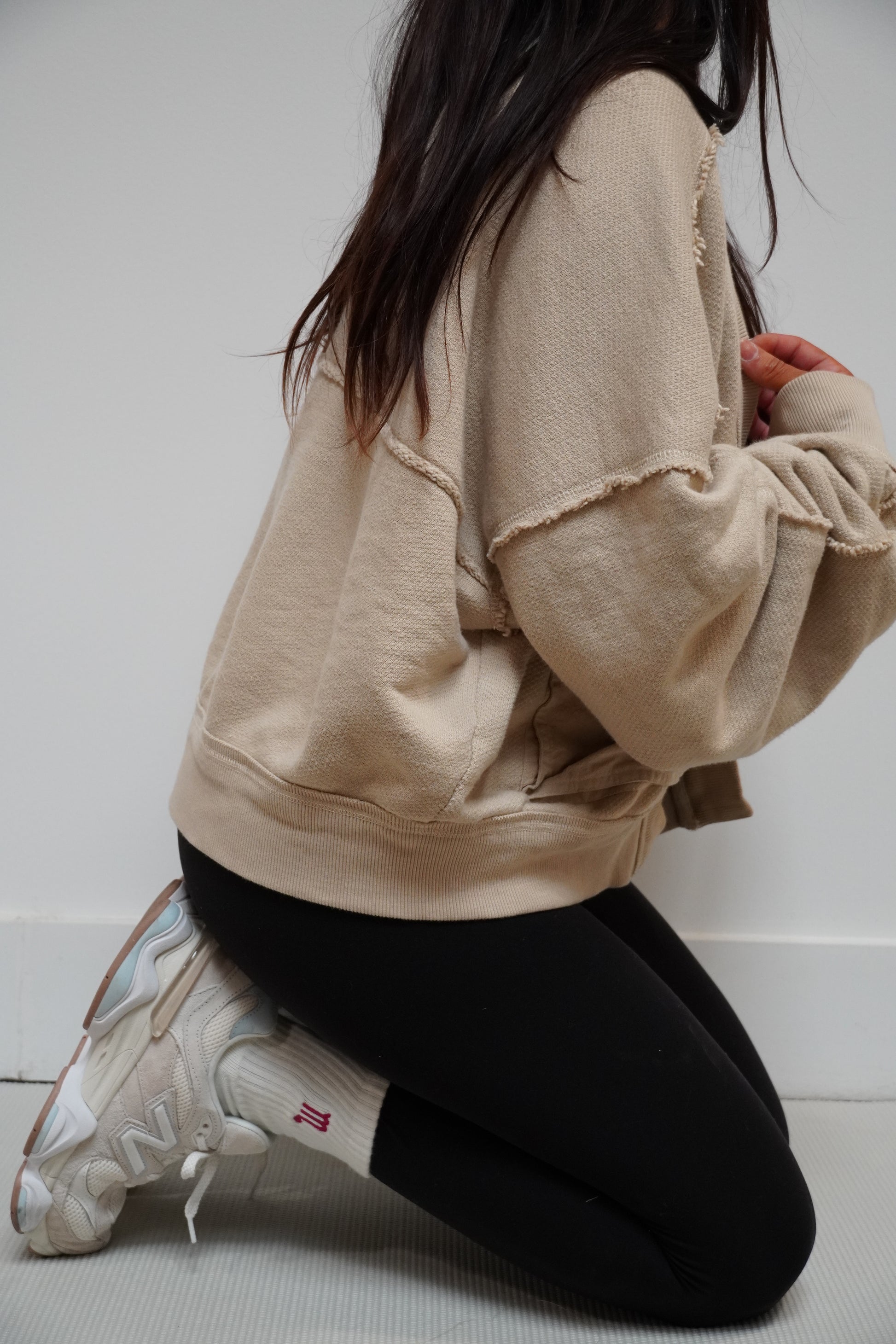 a girl wears a pair of white grip socks with an embroidered zodiac symbol on them in white sneakers