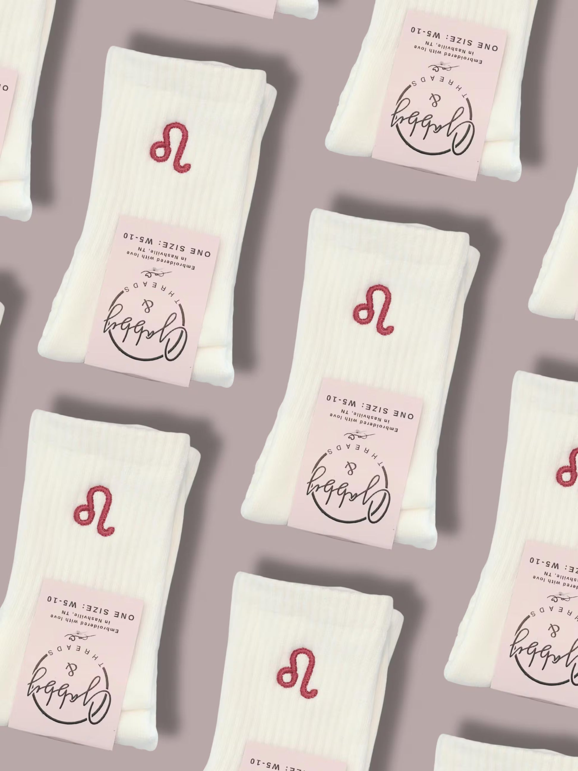 White crew socks with embroidered zodiac sign